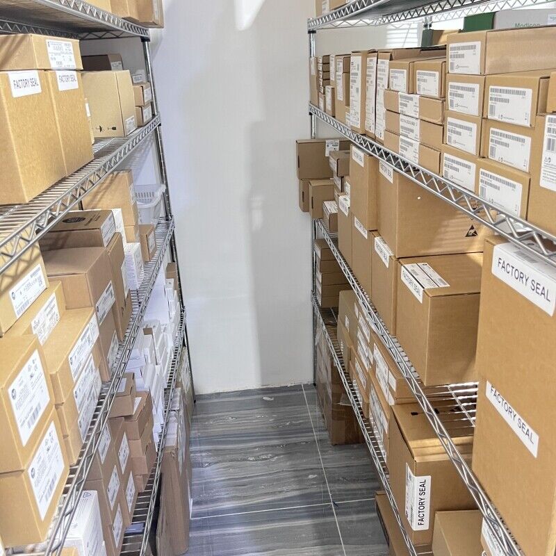 Allen-Bradley parts warehouse, factory sealed boxes, including MicroLogix programming cables.