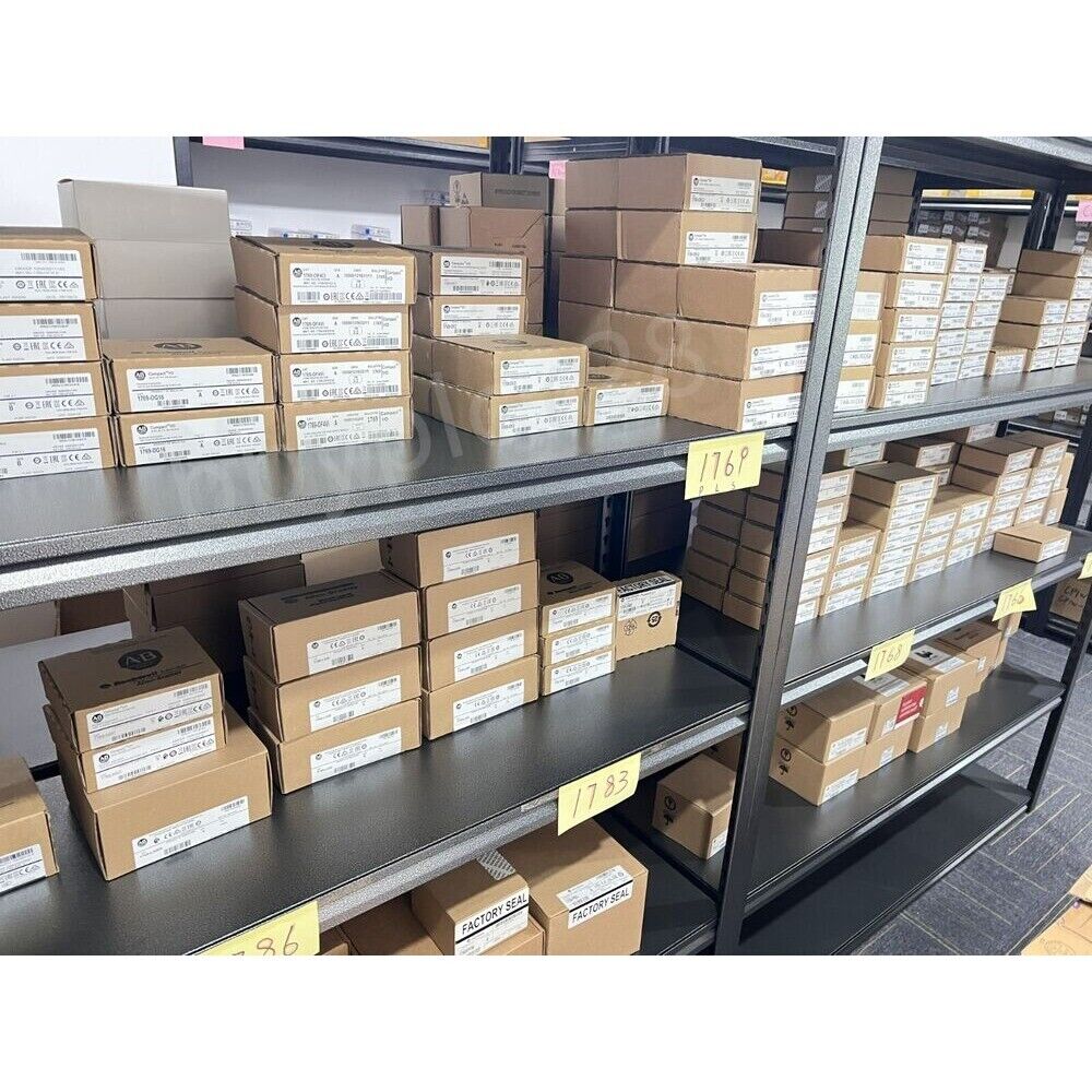 Warehouse stock of Allen-Bradley CompactLogix controllers and automation parts in boxes, product codes visible.