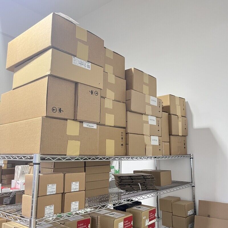 Industrial automation parts storage, stacked cardboard boxes on metal shelves