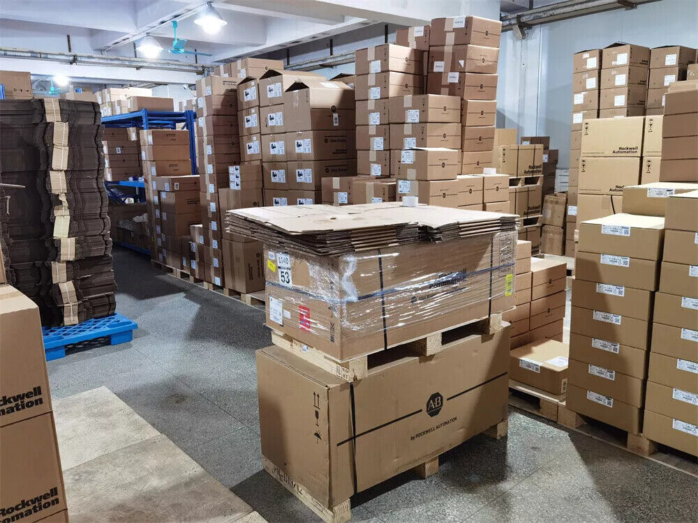 Warehouse of Allen-Bradley industrial automation parts, stacked boxes on pallets, Rockwell Automation