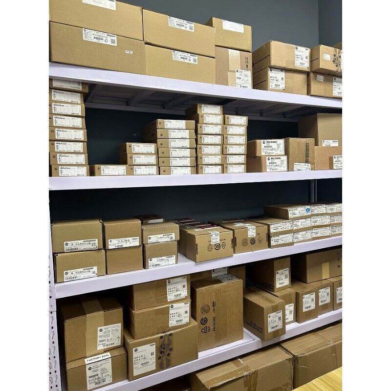 Allen-Bradley PLC products in boxes, organized on warehouse shelves, ready for shipping. AB automation parts.