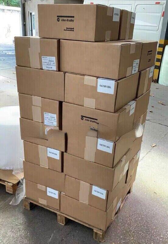 Allen-Bradley PowerFlex 70 AC Drive boxes stacked on a pallet, factory sealed, ready to ship.