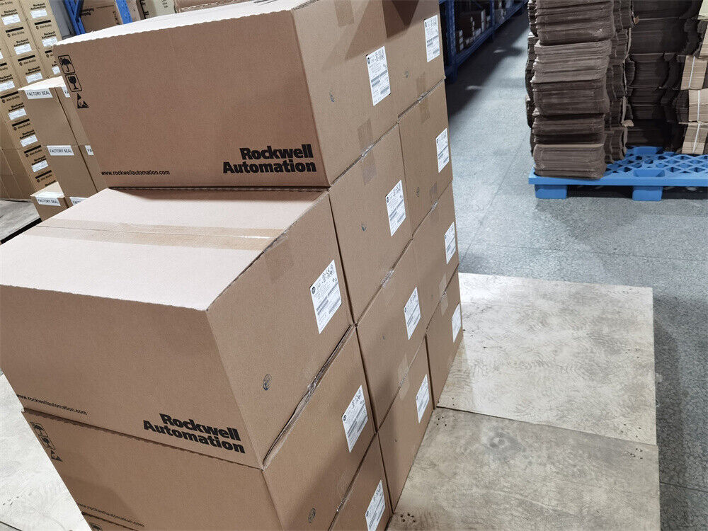 Stack of Rockwell Automation cardboard boxes in warehouse, showcasing product packaging for industrial automation parts.