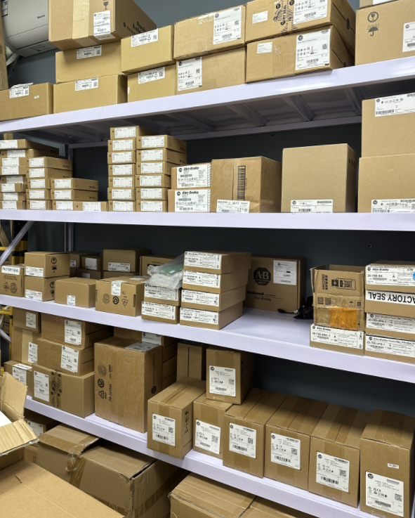 Allen-Bradley PLC parts in boxes on shelves, industrial automation components.