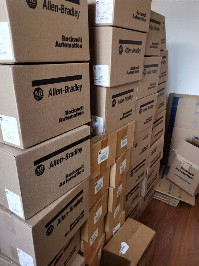 Allen-Bradley Kinetix 350 servo drive boxes in storage, ready for shipment. Rockwell Automation industrial automation parts.