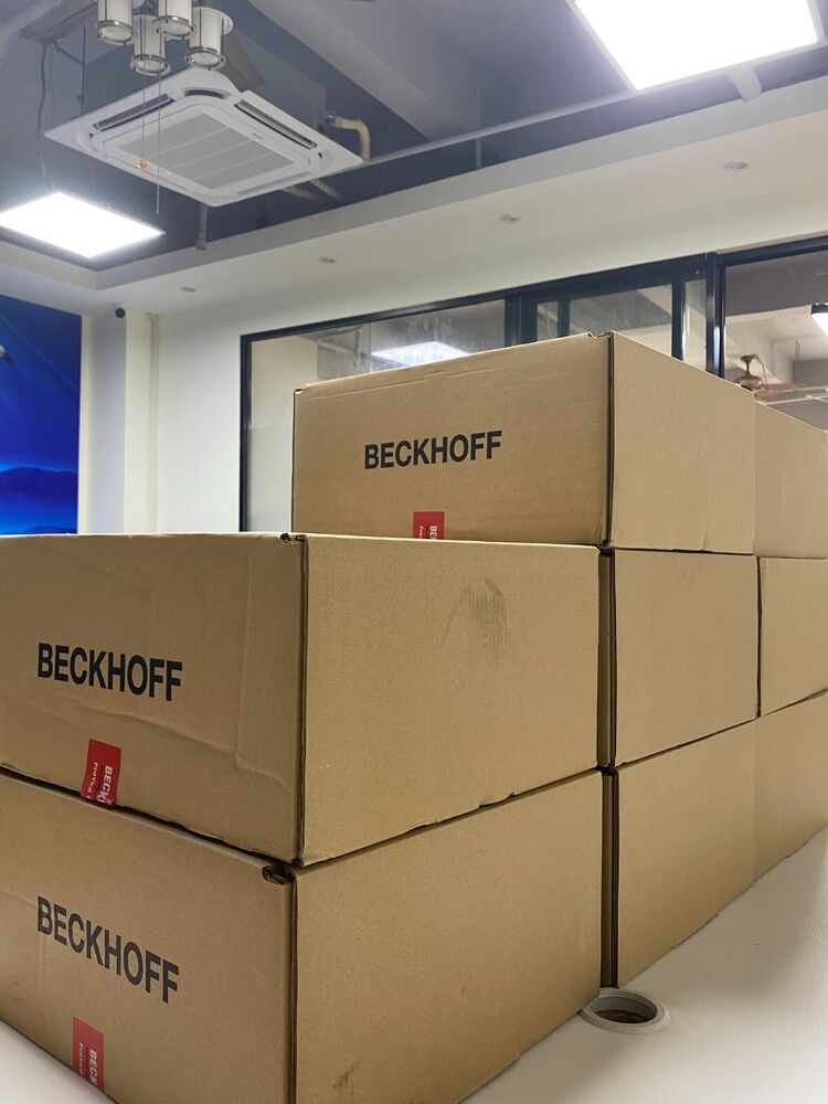 Beckhoff EL7201 Servo Drive Terminals stacked in cardboard boxes, ready for shipment.