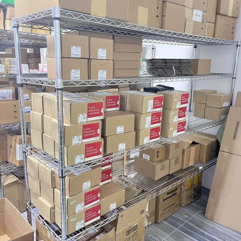 Industrial automation parts storage with boxes, Rockwell Automation, and enterprise connectivity messaging. Metal shelves.