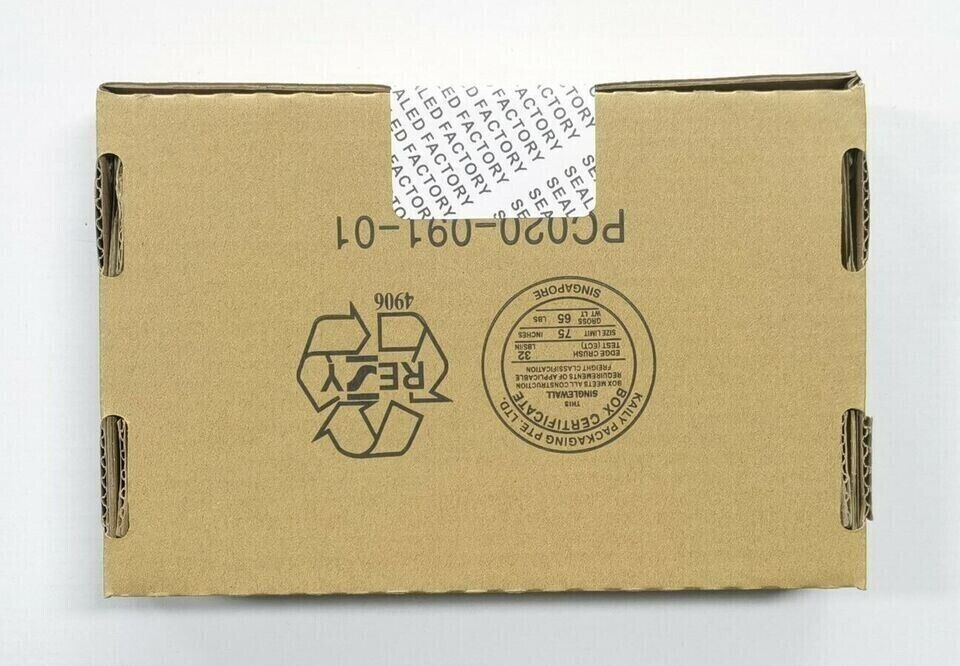 Shipping box for SLC 500 industrial automation parts. Features PC020-091-01, recycling symbol, from Singapore.